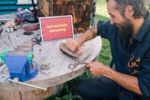 Zac sharpening scissors at his repair café